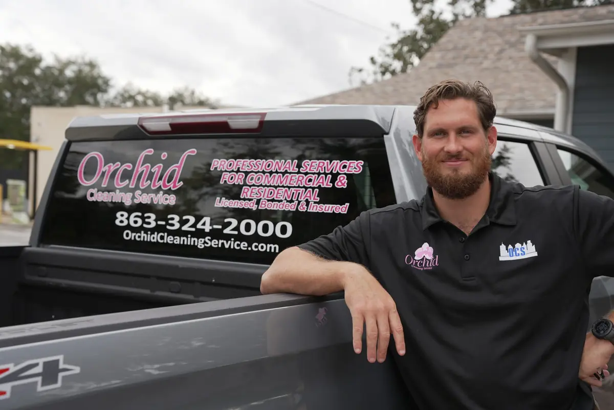 Joey Maher, owner of Orchid Cleaning Service, with the branded company truck in Polk County