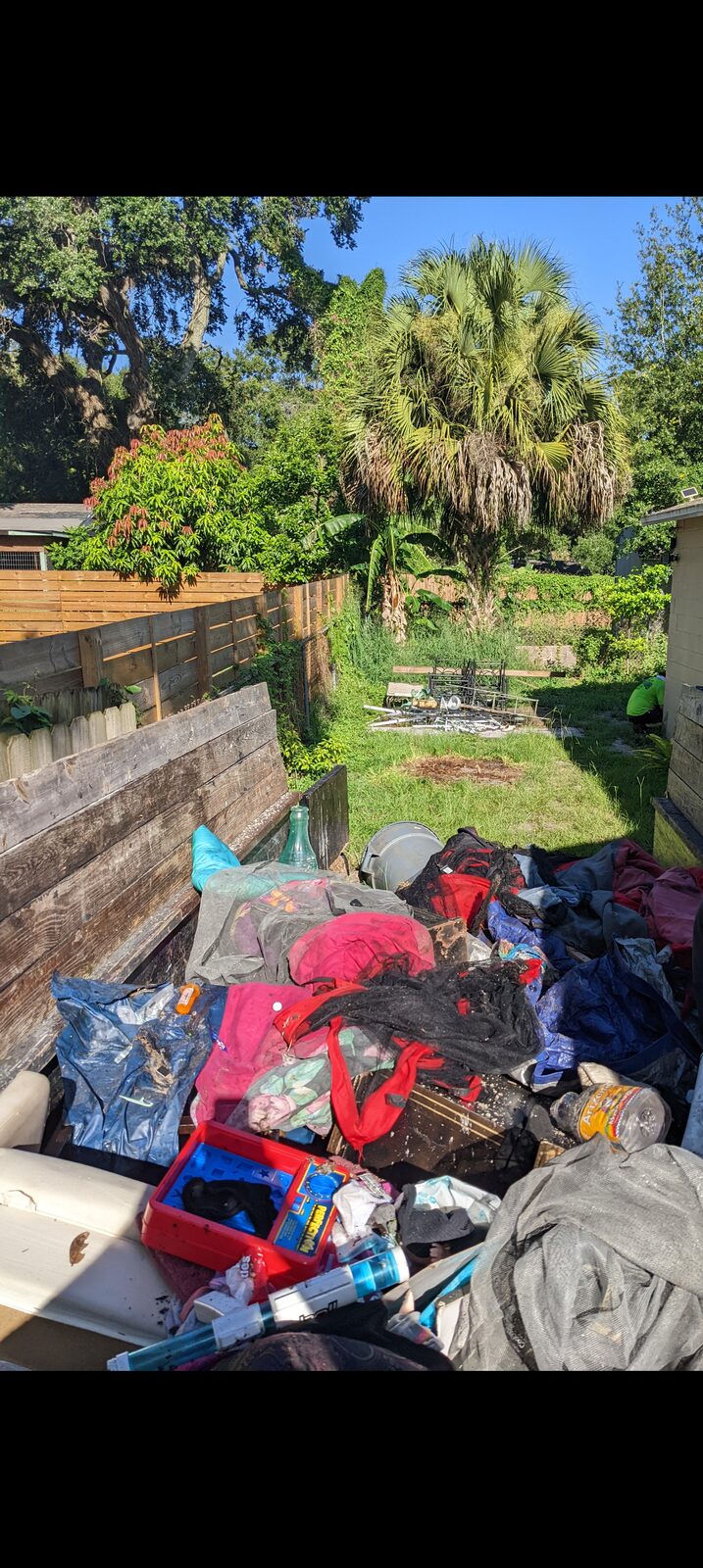 Orchid Cleaning Service team handling a backyard junk and debris removal in Polk County